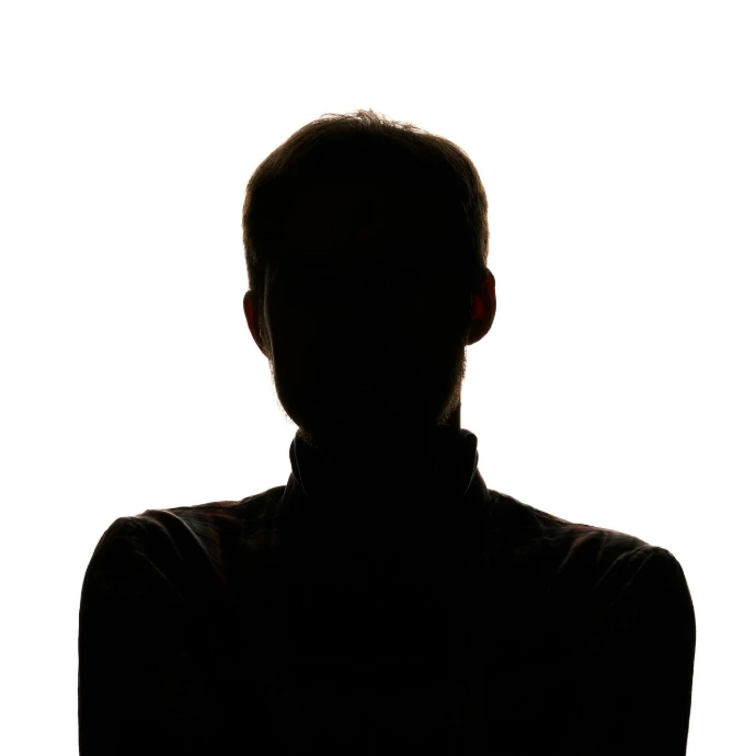 a silhouette of a man with his arms crossed